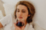 Person sitting quietly at home noticing emotional reliance on alcohol.