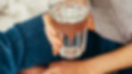 Hands holding a glass of water during alcohol recovery
