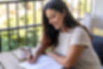 Person in recovery journalling at home during structured alcohol program.