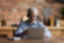 Man participating in an online clinical consultation on a laptop
