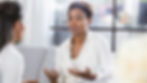 Two people talking, one showing concern and listening attentively — symbolising support for someone with a drinking problem.