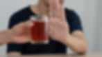 Man turning down an alcoholic drink at a party