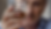Man holding a glass of whisky, face blurred in background contemplating change and how long to rewire brain from addiction.
